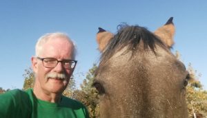 Old man and horse facing camera